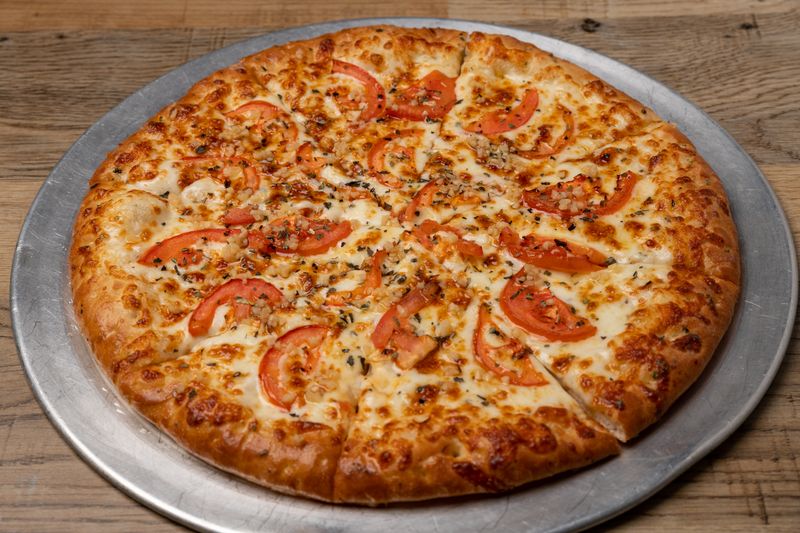 Classic Margherita pizza with fresh tomato and basil